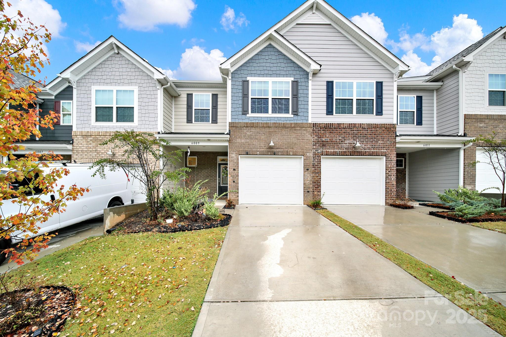 6009 Chelsea Oaks Ridge Fort Mill, SC 29708 - Photo 1 of 30 a front view of a house with a yard and garage