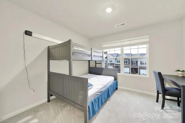 a bed room with a bed and a window