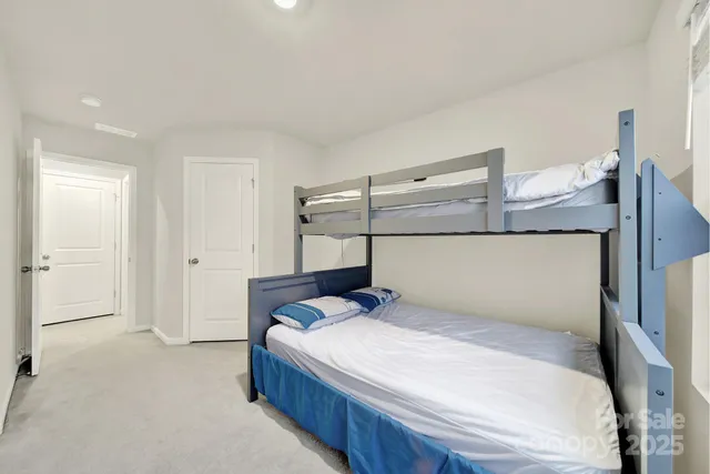 a bedroom with a bed and lamp