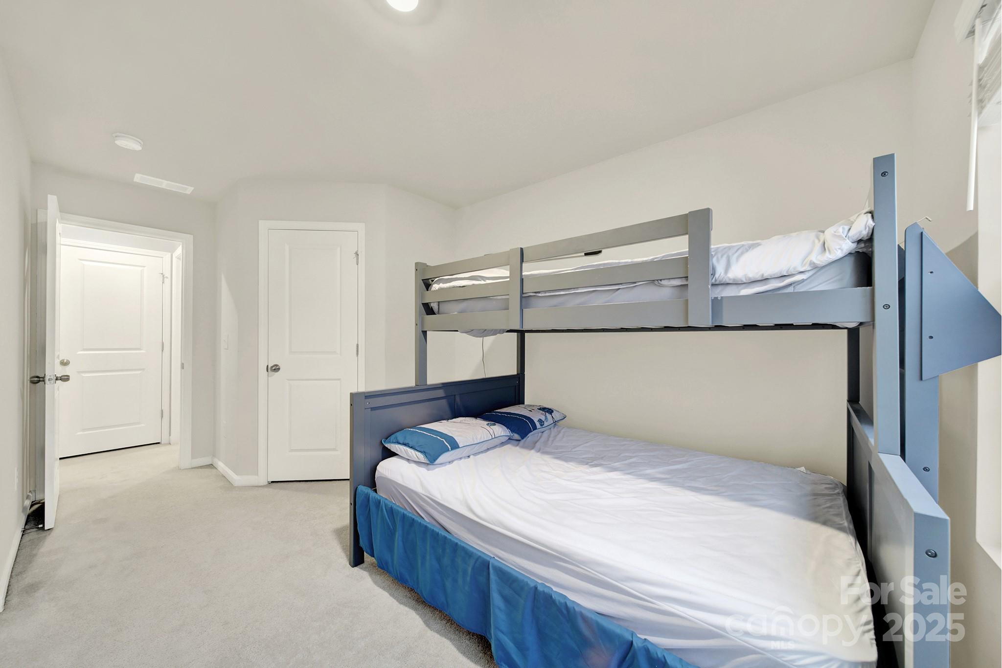 6009 Chelsea Oaks Ridge Fort Mill, SC 29708 - Photo 18 of 30 a bedroom with a bed and lamp