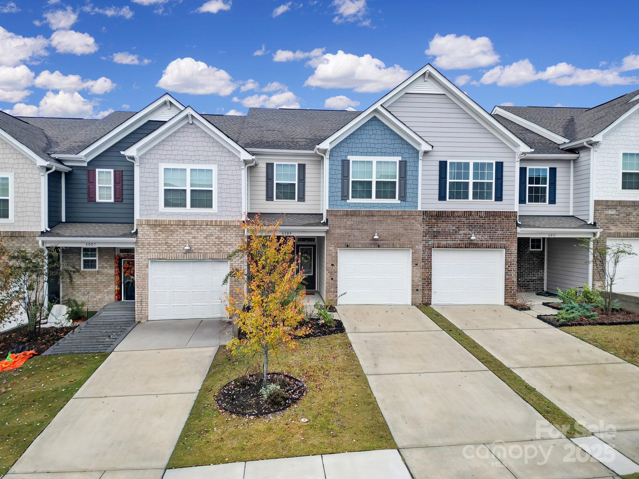 6009 Chelsea Oaks Ridge Fort Mill, SC 29708 - Photo 2 of 30 a front view of a house with a yard and garage
