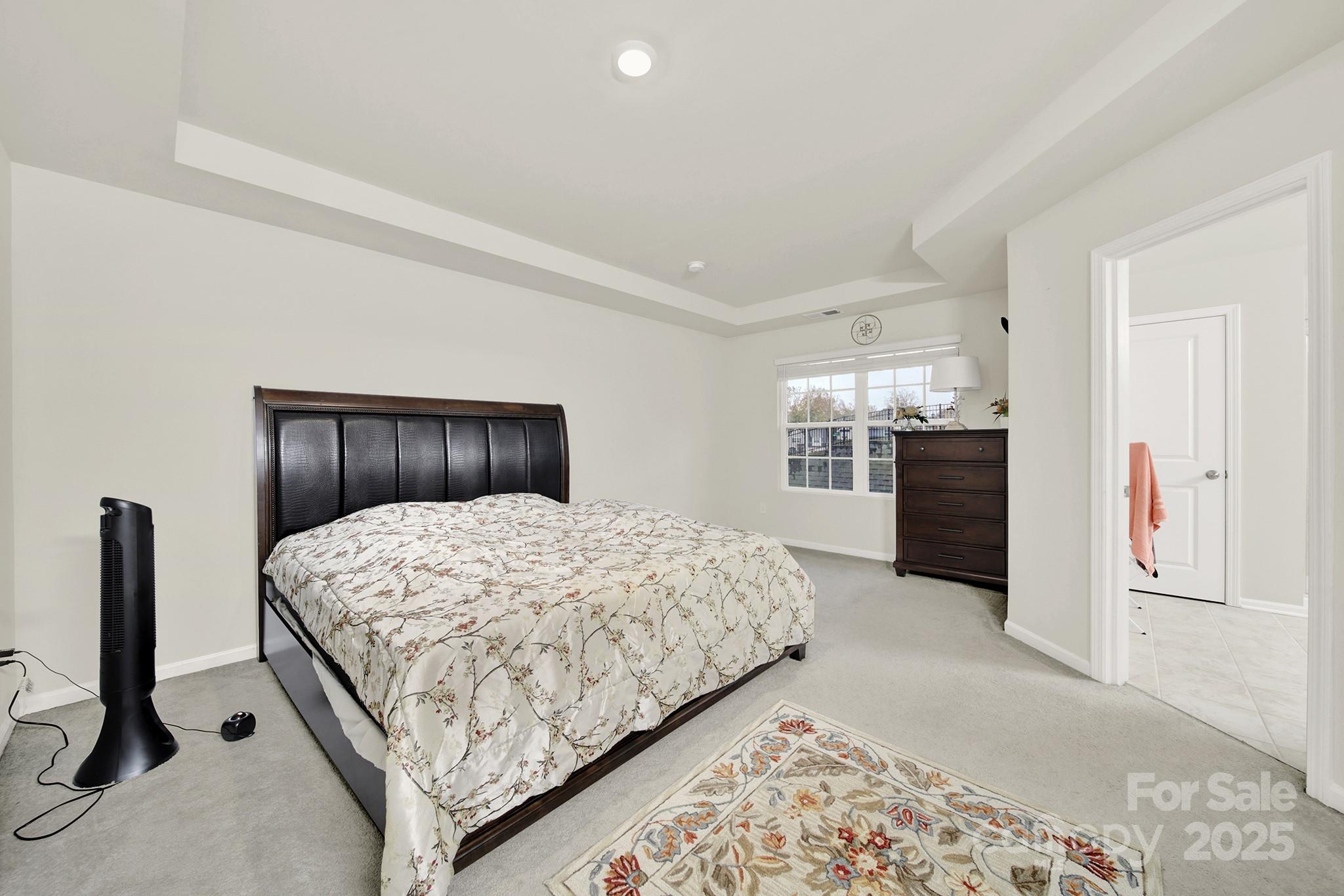 6009 Chelsea Oaks Ridge Fort Mill, SC 29708 - Photo 21 of 30 a bedroom with a large bed and dresser