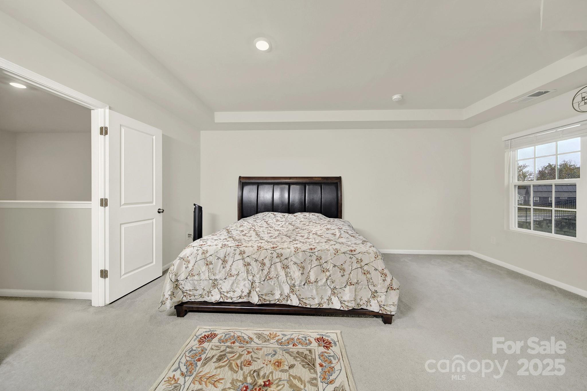 6009 Chelsea Oaks Ridge Fort Mill, SC 29708 - Photo 23 of 30 a bedroom with a bed and a window