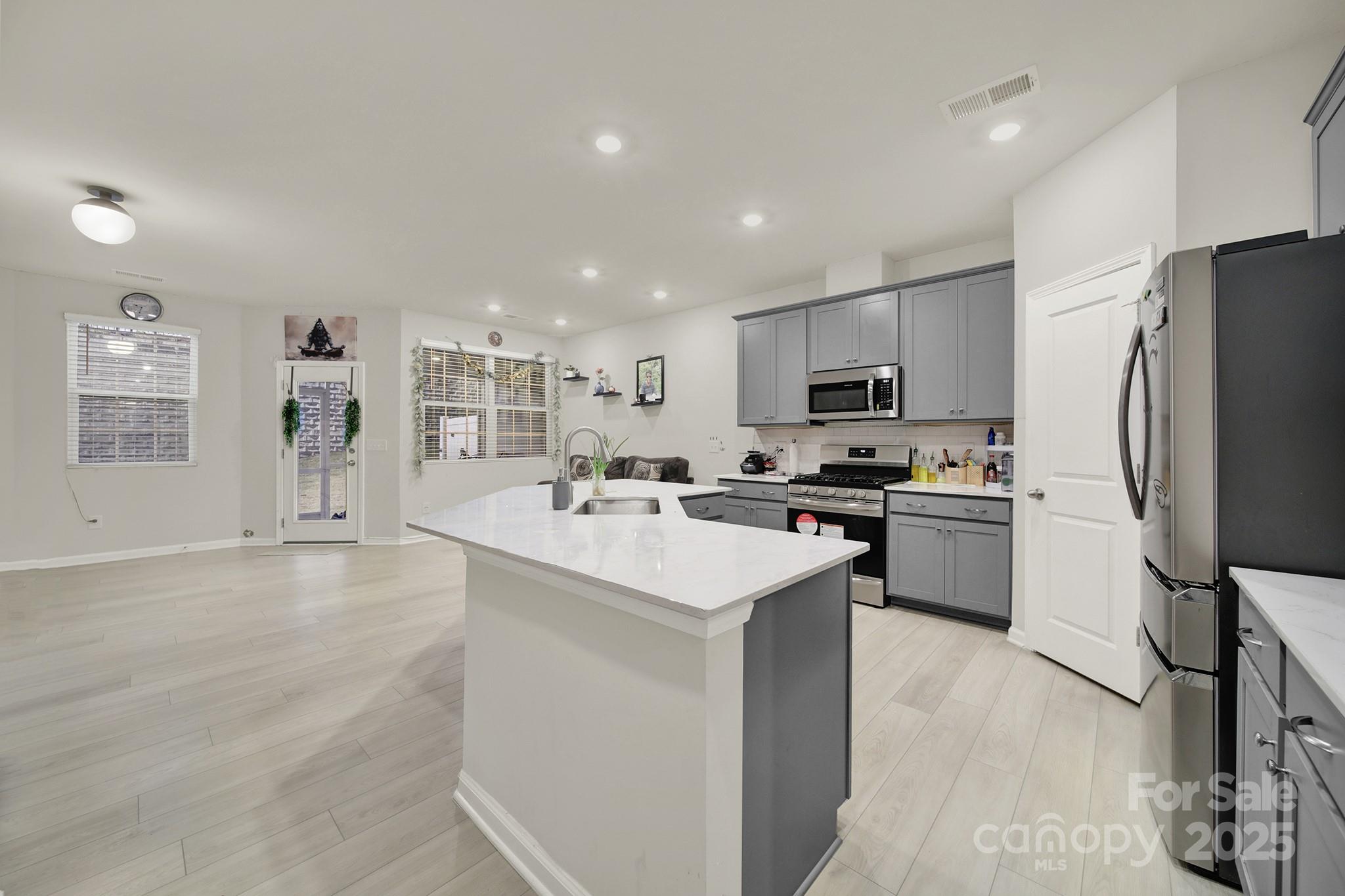 6009 Chelsea Oaks Ridge Fort Mill, SC 29708 - Photo 4 of 30 a kitchen with a sink stainless steel appliances and white cabinets
