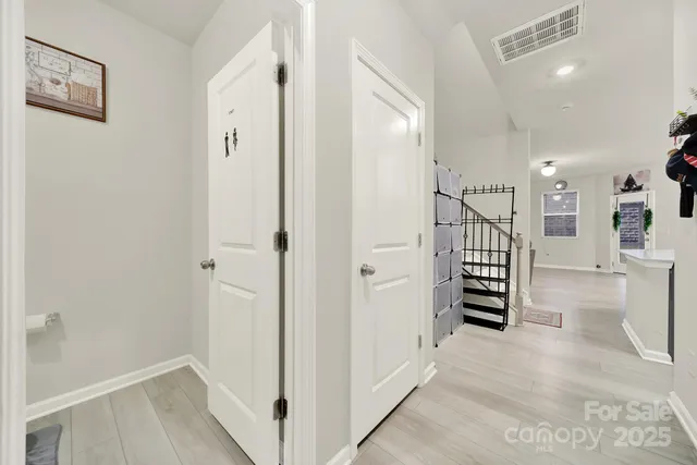 a view of a hallway with wooden floor and staircase