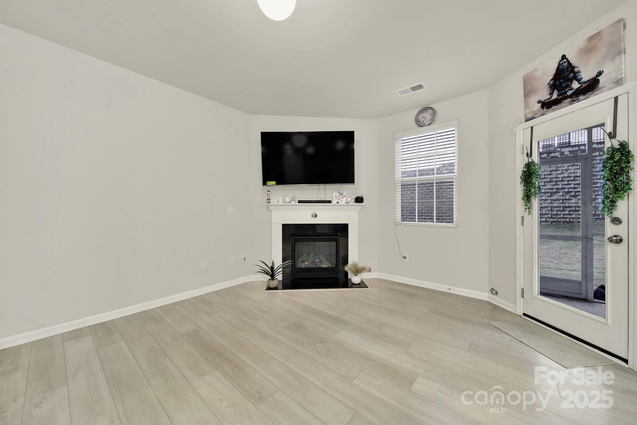 6009 Chelsea Oaks Ridge Fort Mill, SC 29708 - Photo 10 of 30 a view of an empty room with a fireplace and a window