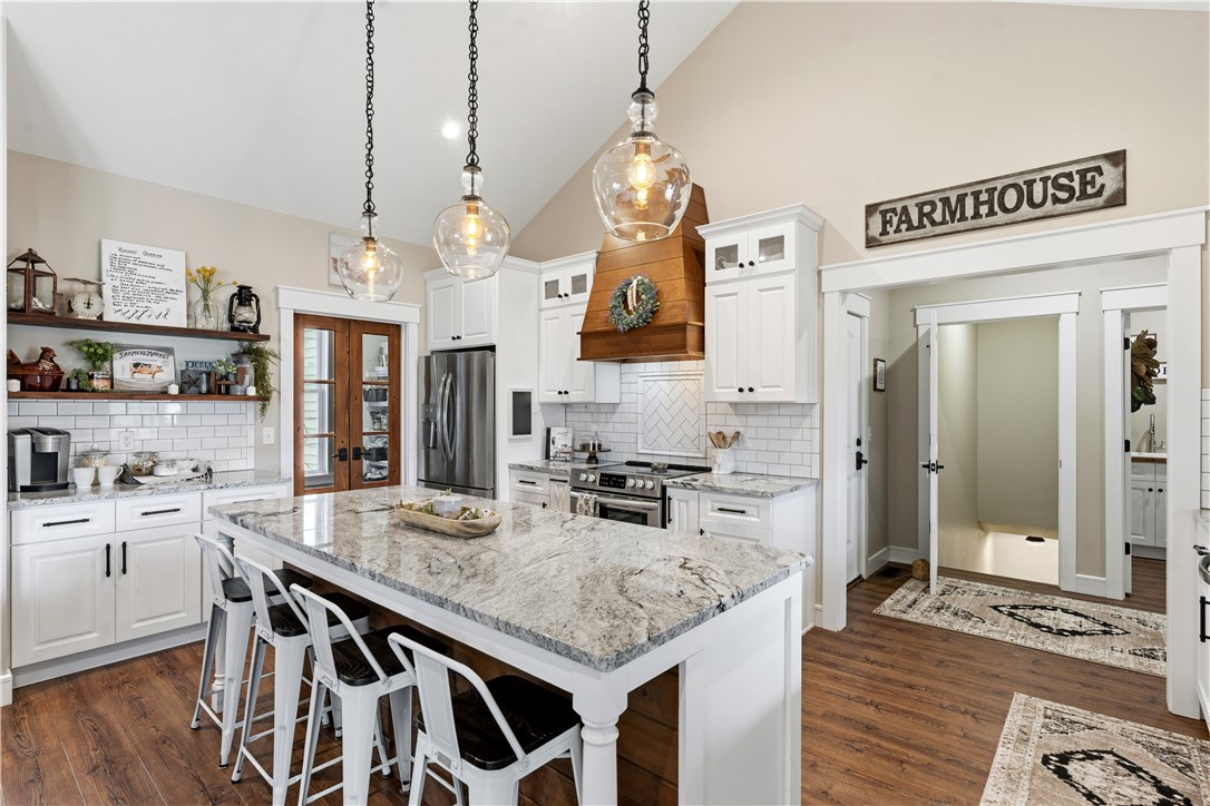 1158 Pyle Road Clarksville, OH 45113 - Photo 21 of 76 This spacious kitchen offers a large island with seating, a vaulted ceiling, and ample cabinet space.