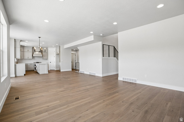 11781 South Halls Crk Road Draper, UT 84020 - Photo 9 of 33 Open-concept living area featuring wood-finish flooring, recessed lighting, and white baseboards