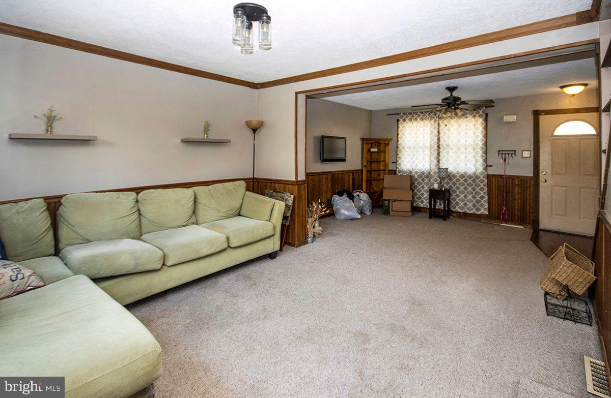 315 Cornell Road Glassboro, NJ 08028 - Photo 11 of 22 a living room with furniture and a chandelier