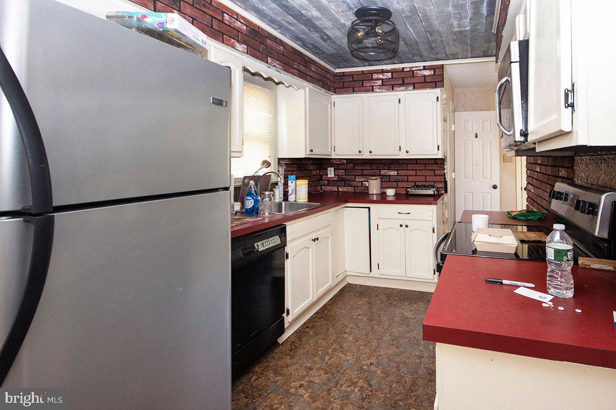 315 Cornell Road Glassboro, NJ 08028 - Photo 13 of 22 a kitchen with a refrigerator and a sink