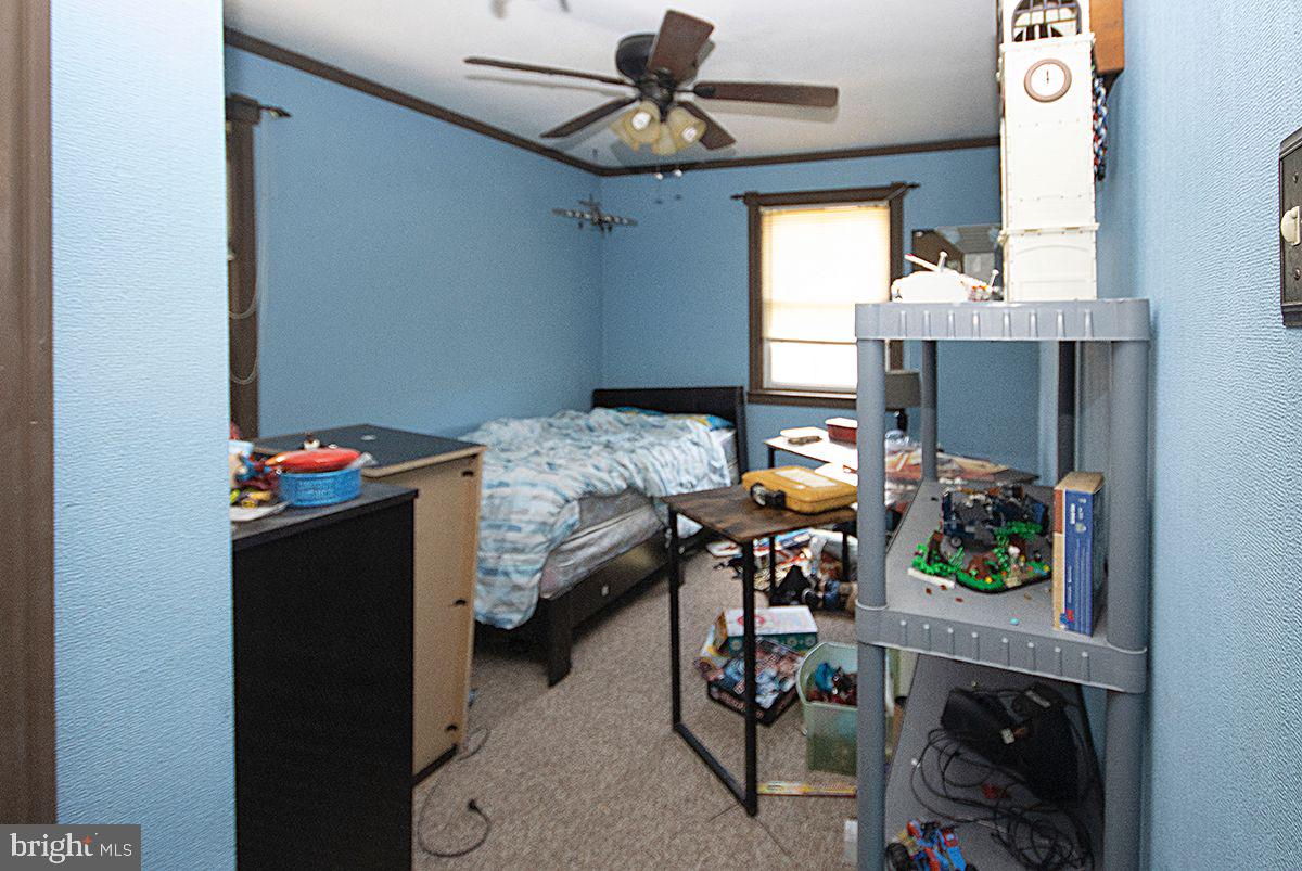 315 Cornell Road Glassboro, NJ 08028 - Photo 17 of 22 a bedroom with a bed and a chandelier