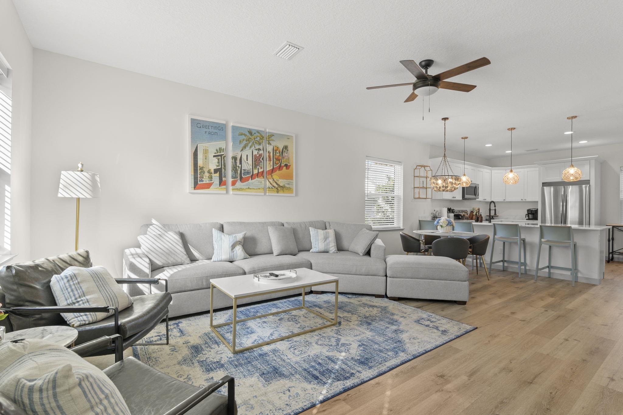 a living room with furniture and kitchen view