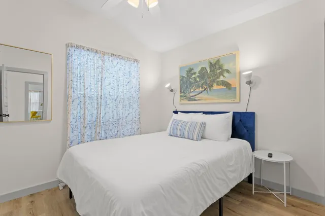 a bedroom with a bed and wooden floor