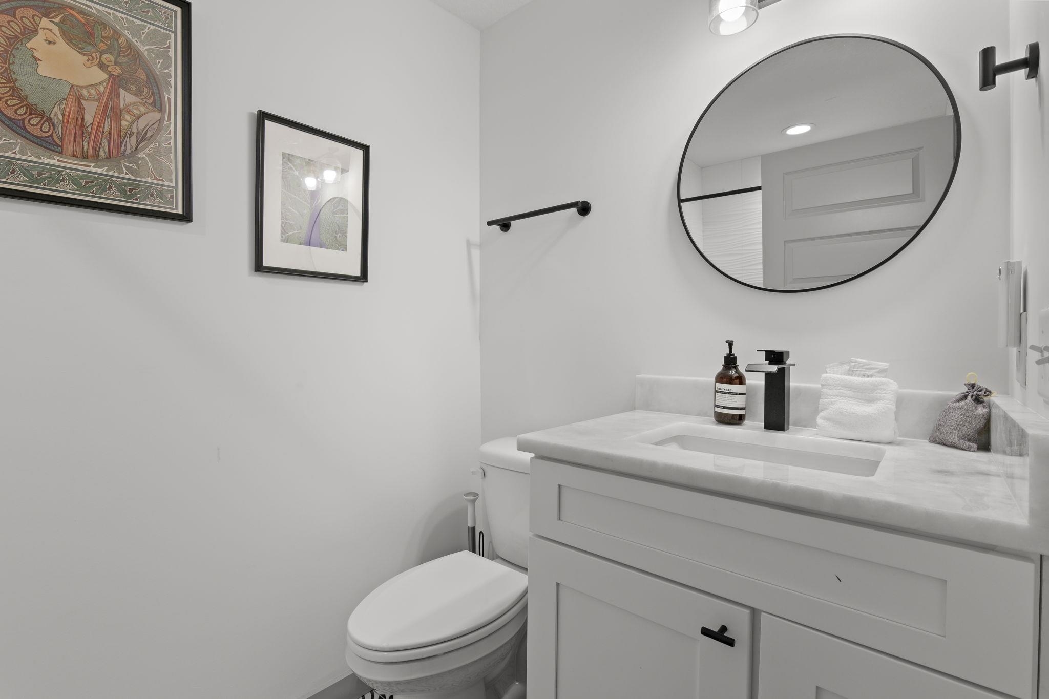 110 Moore Street St. Augustine, FL 32084 - Photo 21 of 39 a bathroom with a granite countertop toilet a sink and mirror