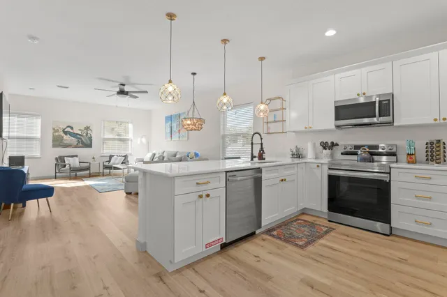 a living room with furniture and kitchen view