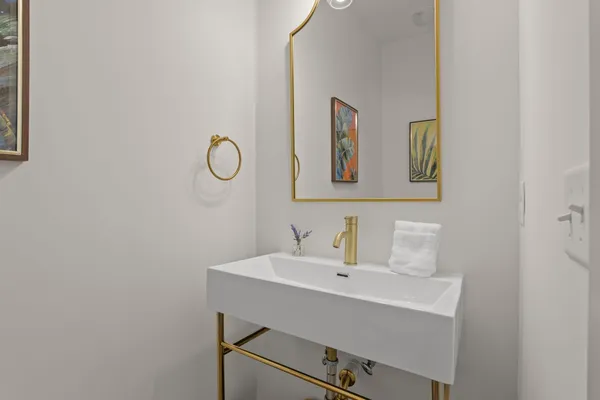a bathroom with a granite countertop toilet a sink and mirror