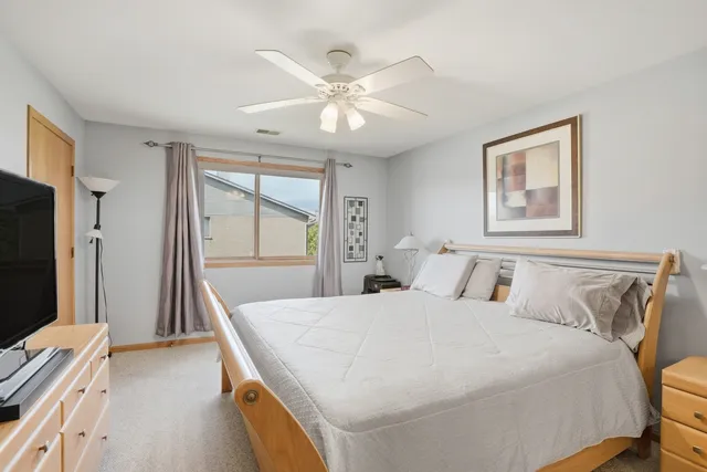 a bedroom with a large bed and a chandelier