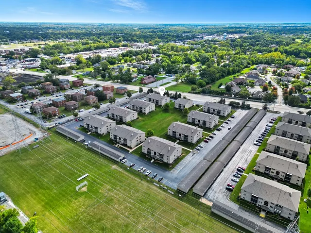 an aerial view of a house with a yard table and chairs