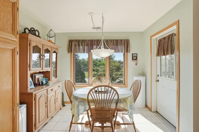 a view of a dining room with furniture and chandelier