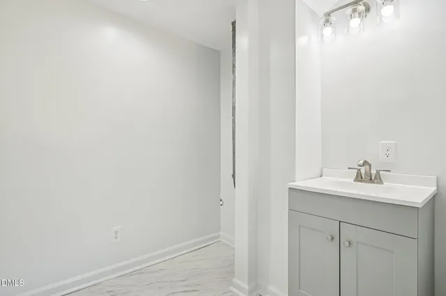 a bathroom with a toilet a sink and a window