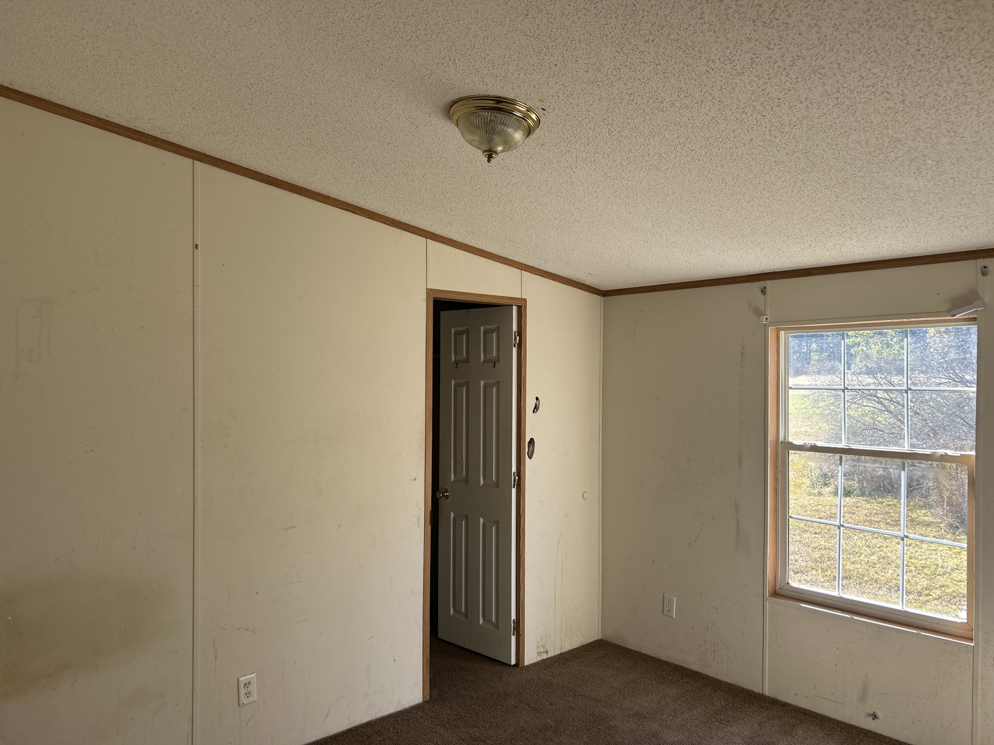 784 Garrison Road Hohenwald, TN 38462 - Photo 15 of 36 a view of an empty room with a window