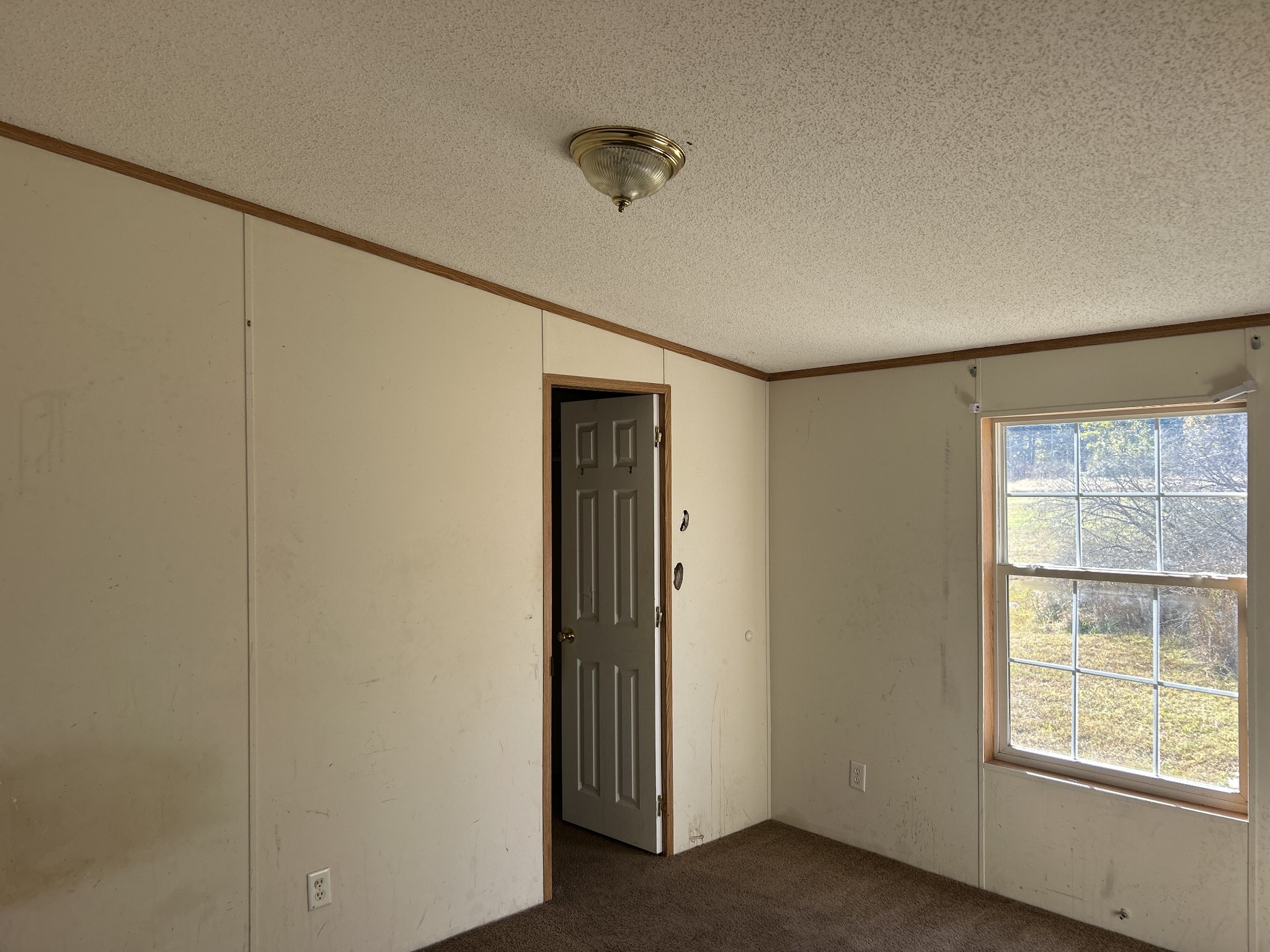 784 Garrison Road Hohenwald, TN 38462 - Photo 16 of 36 a view of an empty room with a window