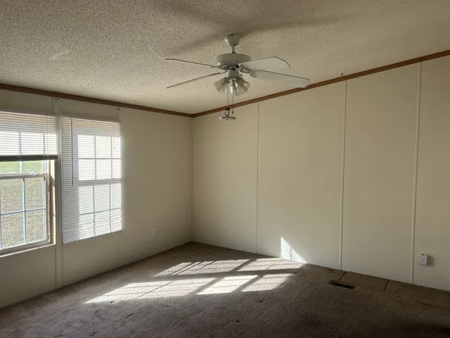 a view of room with a ceiling fan and window