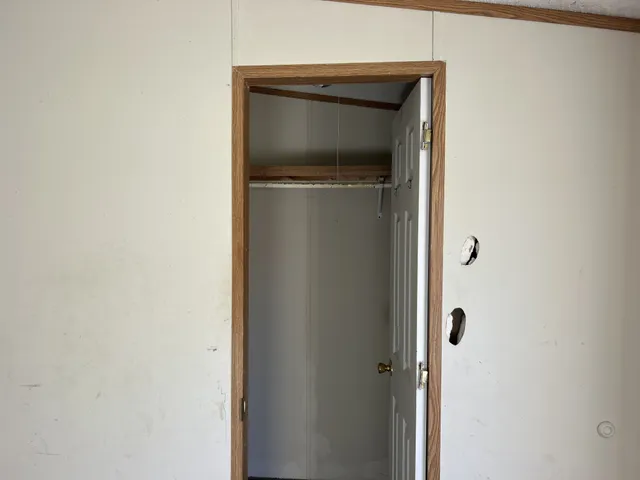 an empty room with a window and a ceiling fan