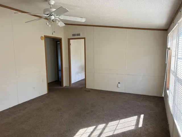 an empty room with windows and closet