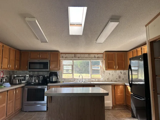 a view of an empty room with a fireplace