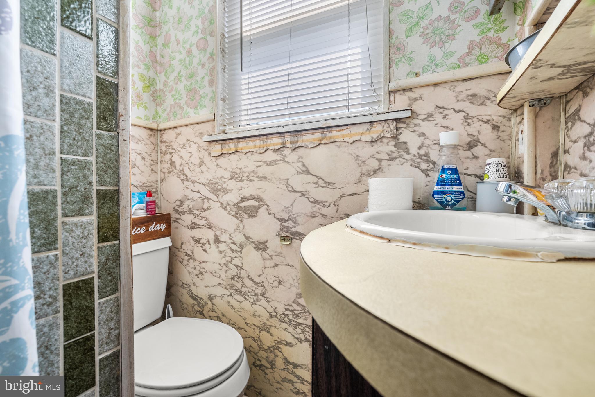130 Madison Street Riverside, NJ 08075 - Photo 23 of 38 a bathroom with a sink a toilet and a window