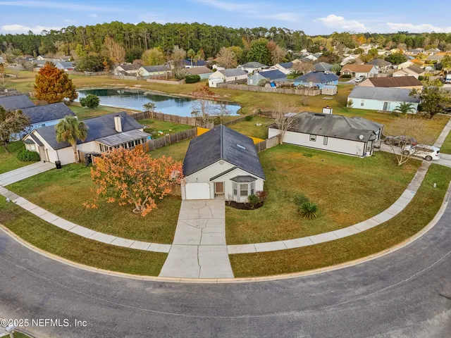 an aerial view of residential houses with outdoor space