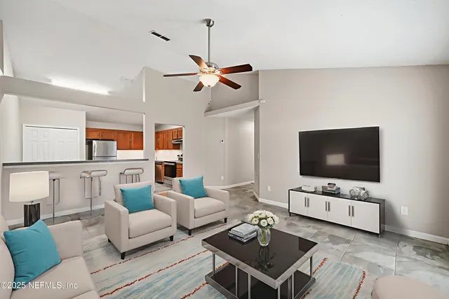 a living room with furniture a rug and a flat screen tv