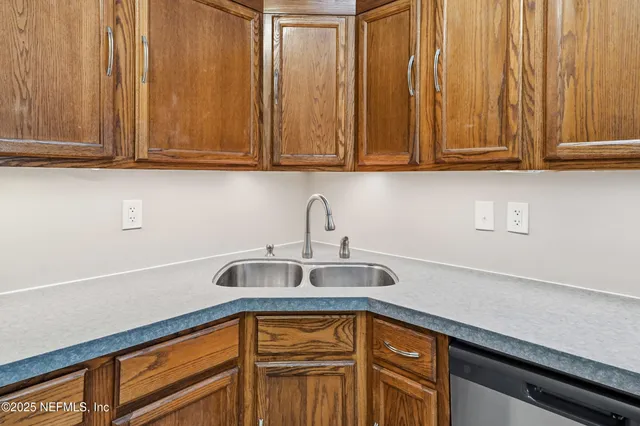 a kitchen with stainless steel appliances granite countertop white cabinets and a sink