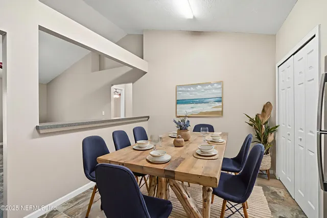 a view of a dining room with furniture and window
