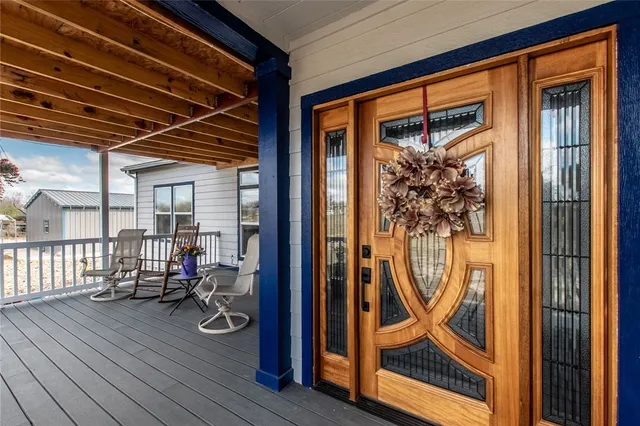 a view of a chair and tables on the wooden deck