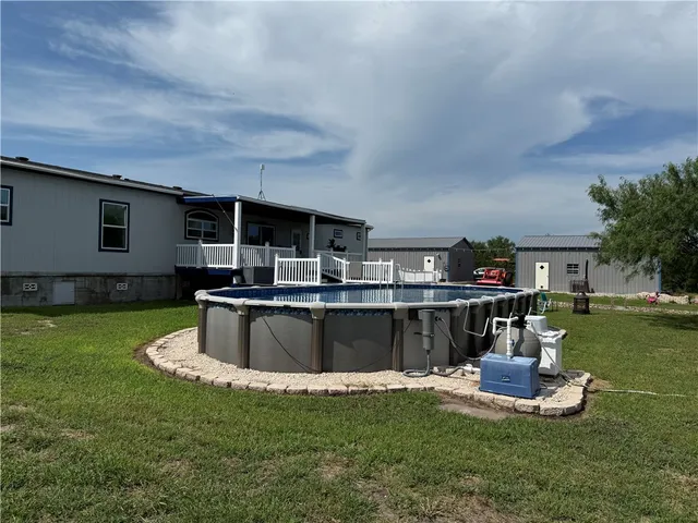 a dining room with furniture a rug and a chandelier