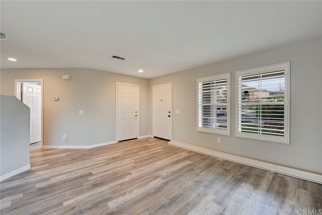 23571 Fallen Boulder Road Menifee, CA 92587 - Photo 11 of 33 a view of an empty room with wooden floor and a window
