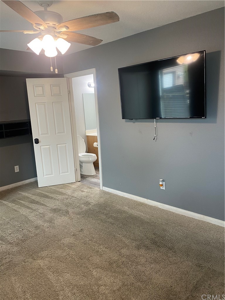 23571 Fallen Boulder Road Menifee, CA 92587 - Photo 20 of 33 a view of a livingroom with an empty space and a flat screen tv