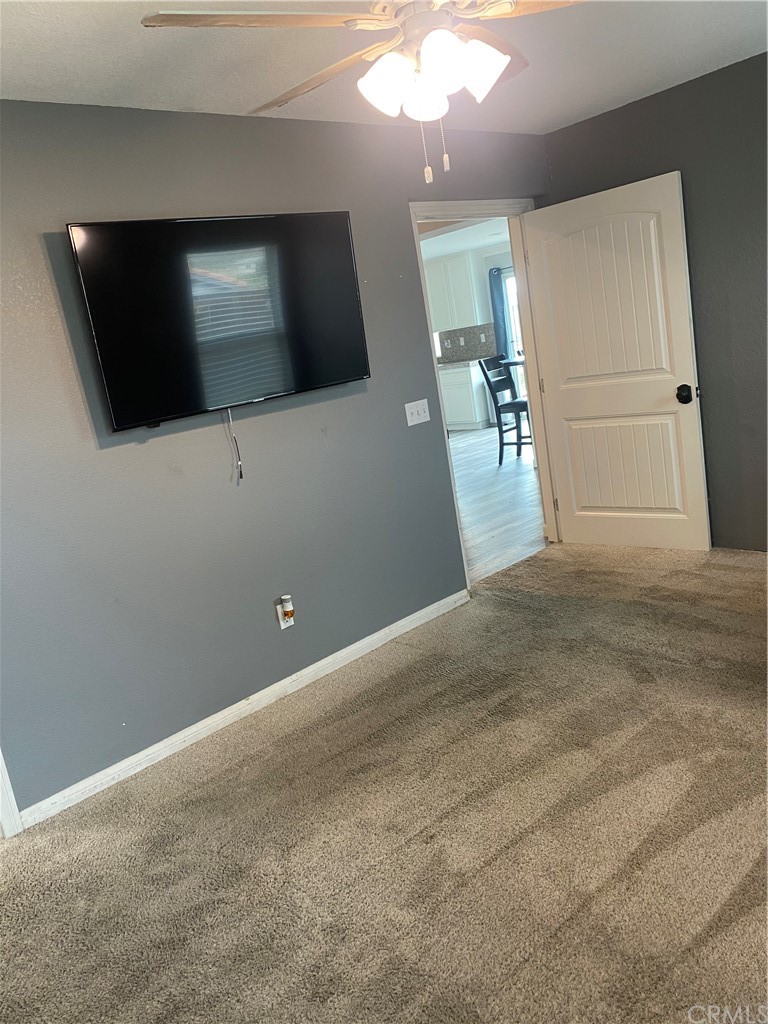 23571 Fallen Boulder Road Menifee, CA 92587 - Photo 21 of 33 a view of a livingroom with an empty space and a flat screen tv