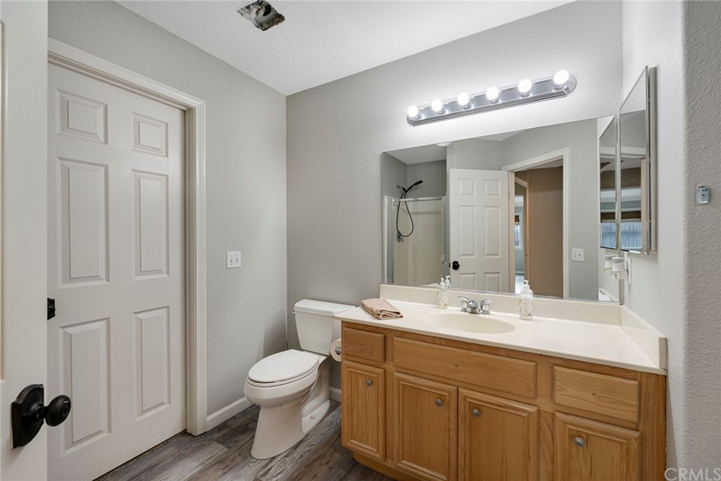 23571 Fallen Boulder Road Menifee, CA 92587 - Photo 23 of 33 a bathroom with a toilet a sink and mirror