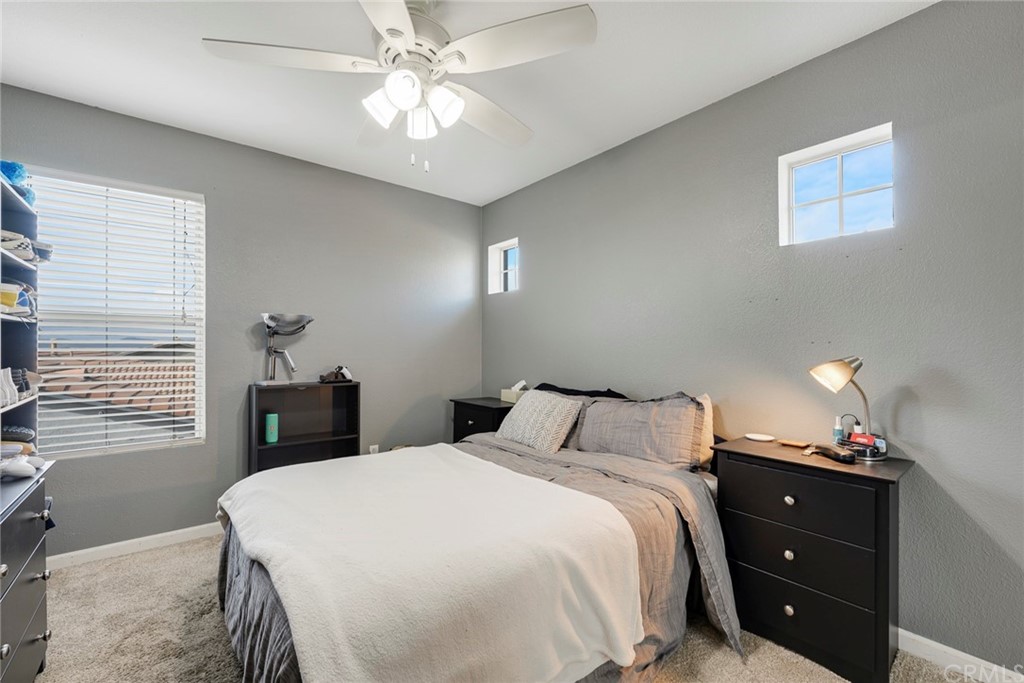 23571 Fallen Boulder Road Menifee, CA 92587 - Photo 24 of 33 a bedroom with a bed and a chandelier