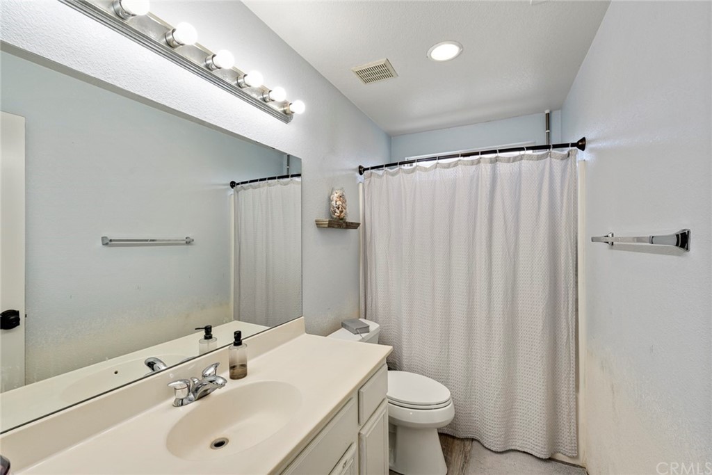 23571 Fallen Boulder Road Menifee, CA 92587 - Photo 26 of 33 a bathroom with a sink and a mirror