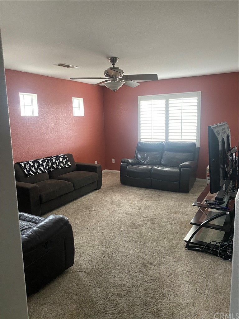 23571 Fallen Boulder Road Menifee, CA 92587 - Photo 33 of 33 a living room with furniture and a window