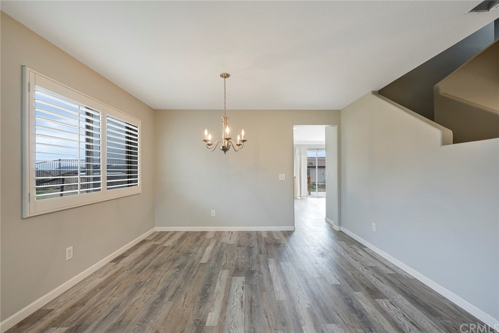 23571 Fallen Boulder Road Menifee, CA 92587 - Photo 7 of 33 a view of livingroom with hardwood floor and kitchen view