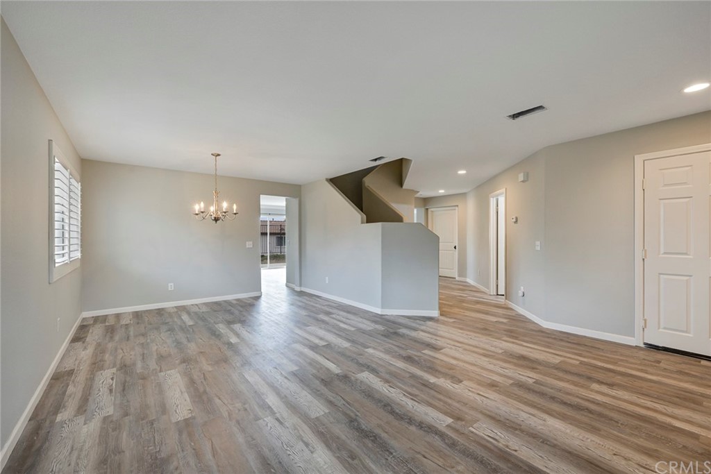23571 Fallen Boulder Road Menifee, CA 92587 - Photo 8 of 33 a view of an empty room with wooden floor and a window