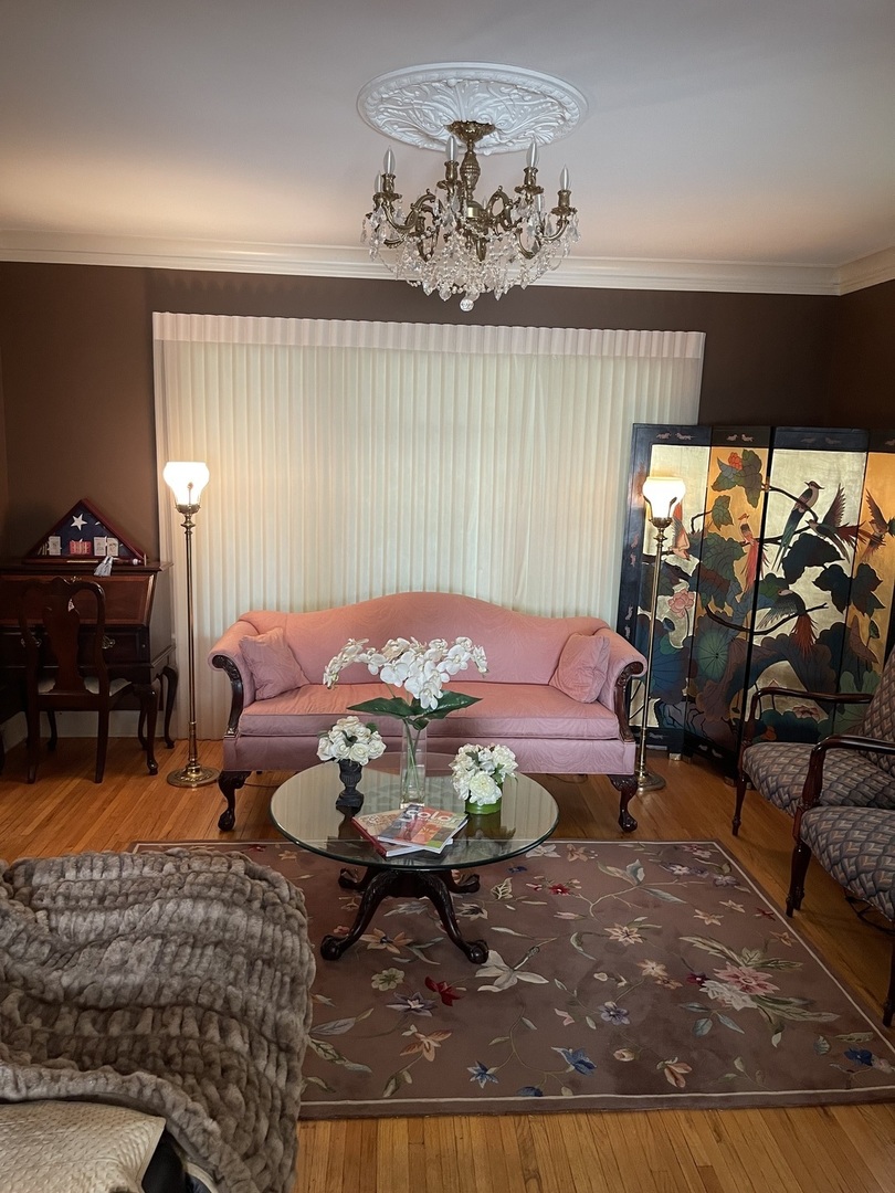 Undisclosed Address Chicago, IL 60643 - Photo 13 of 19 a living room with furniture a rug and a chandelier