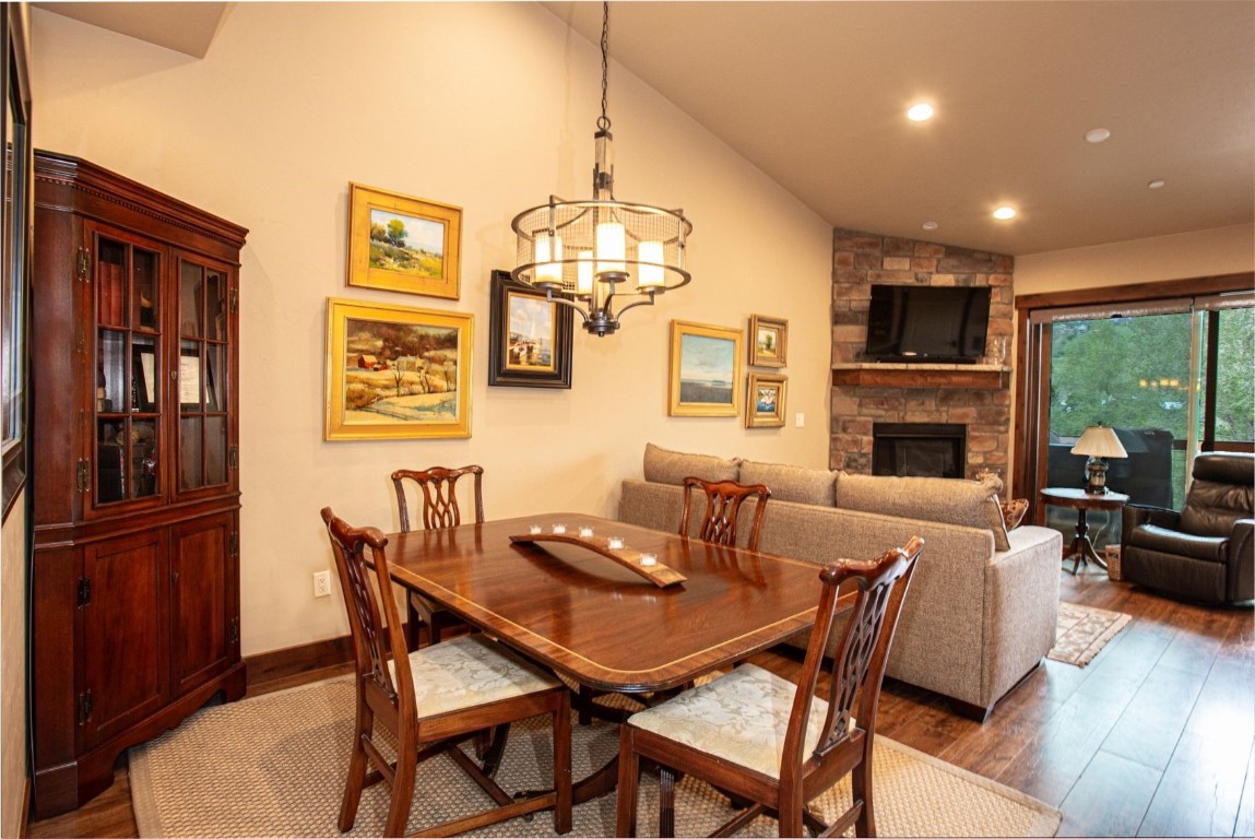 421 Rainbow Drive, Unit 5 Silverthorne, CO 80498 - Photo 11 of 36 a dining room with furniture a chandelier and wooden floor