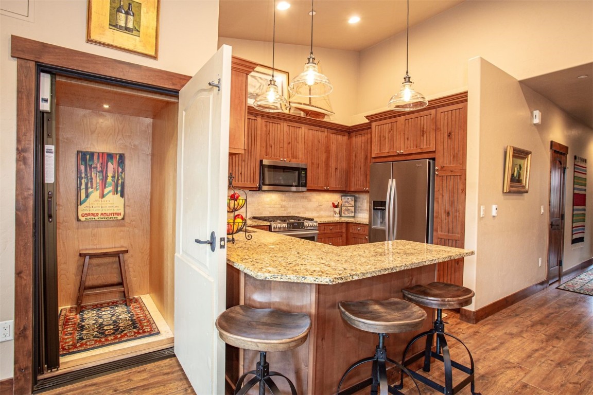 421 Rainbow Drive, Unit 5 Silverthorne, CO 80498 - Photo 13 of 36 a kitchen with refrigerator cabinets and wooden floor