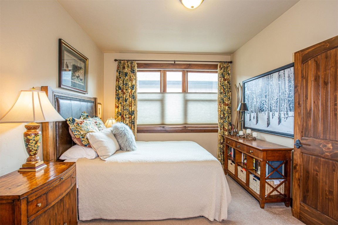 421 Rainbow Drive, Unit 5 Silverthorne, CO 80498 - Photo 20 of 36 a bedroom with a bed and a window